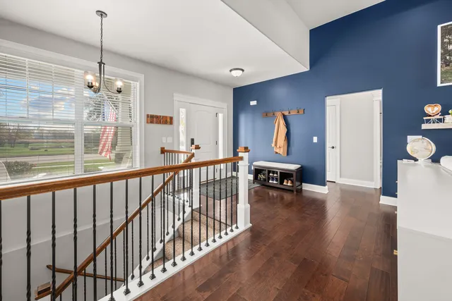 a view of a living room and entryway with wooden floor