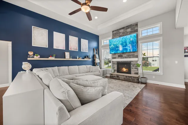 a living room with a fireplace windows and a fireplace