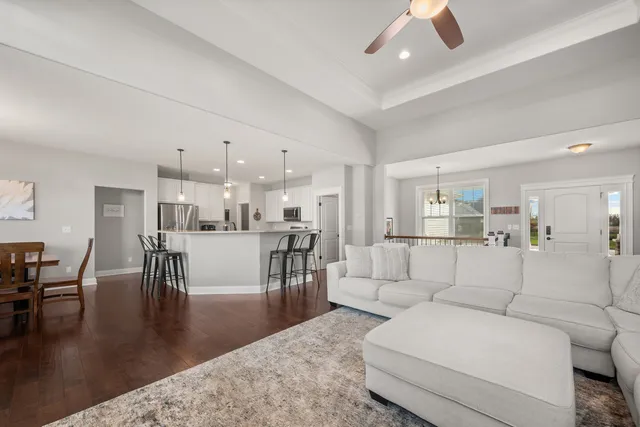 a view of a dining room with furniture wooden floor and a chandelier