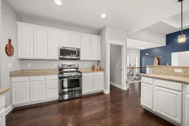 a bedroom with a bed and a flat tv screen on dresser