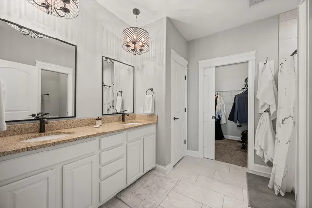 a view of walk in closet with clothes