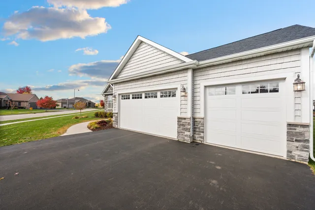 a view of a house with a yard and garage