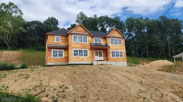 a front view of a house with yard and garage
