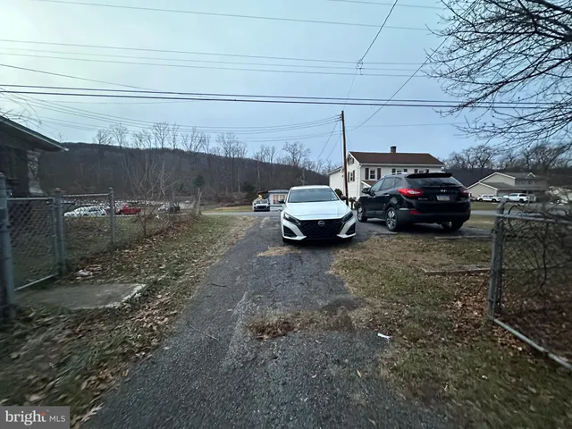 a living room with furniture and a mirror