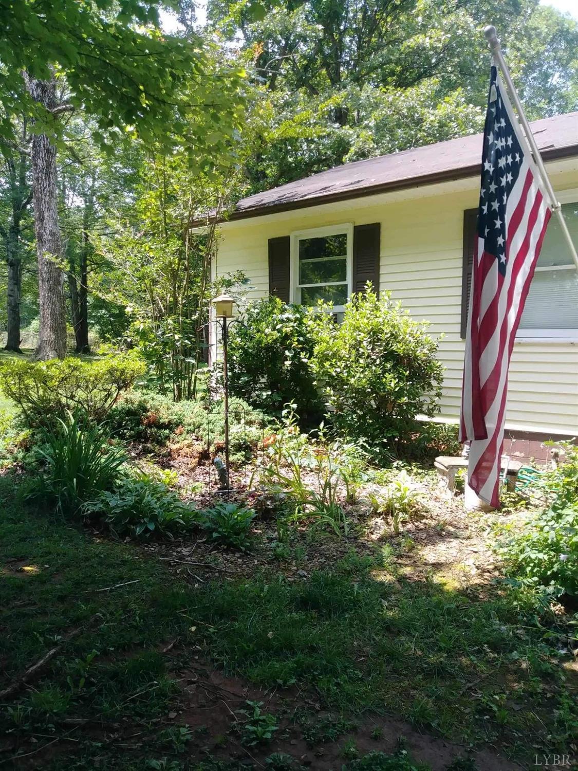283 Village Road Shipman, VA 22971 - Photo 3 of 12 a view of a house with a yard and potted plants