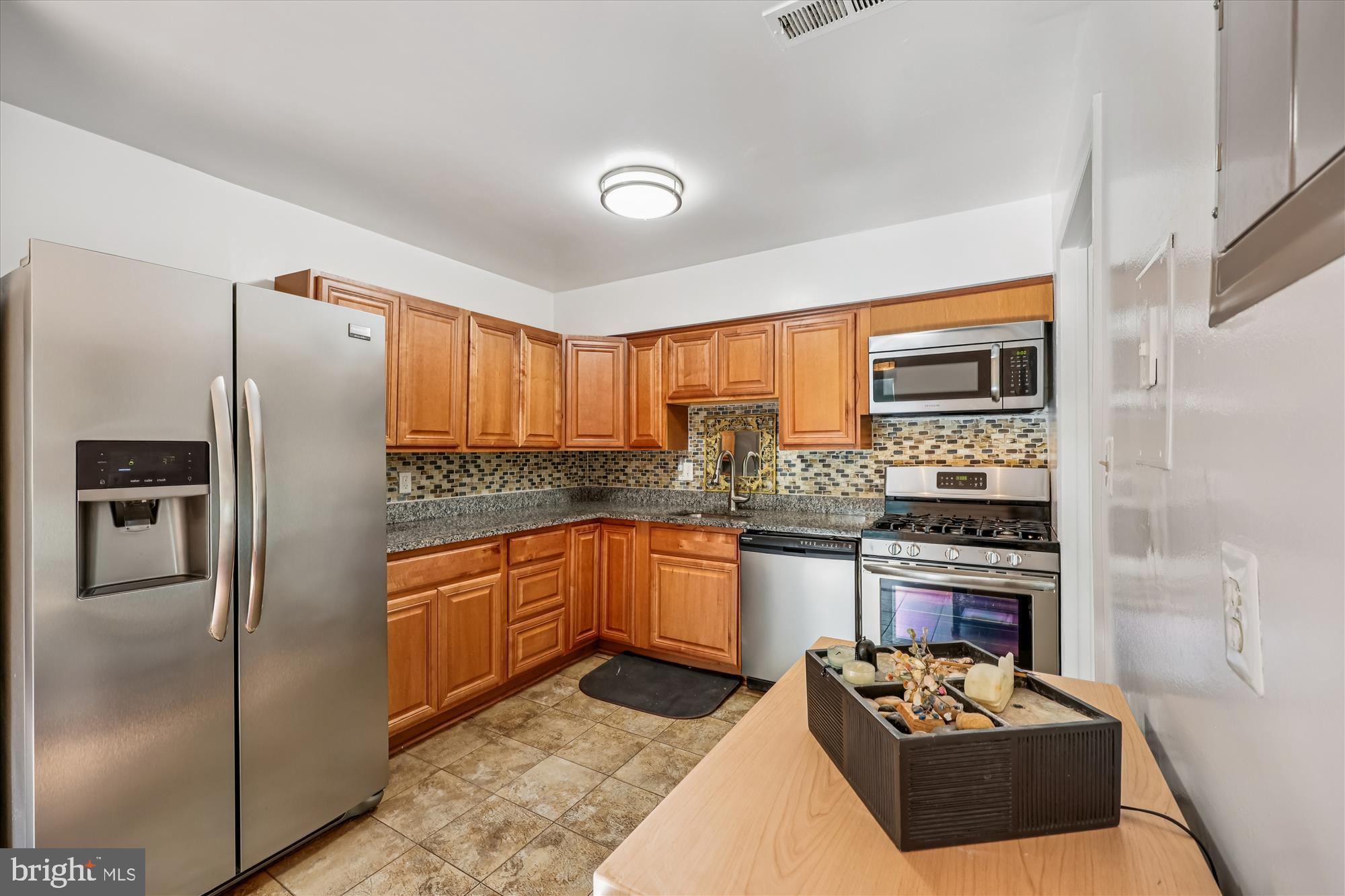 14428 Parkvale Road, Unit 3 Rockville, MD 20853 - Photo 11 of 37 a kitchen with stainless steel appliances granite countertop a refrigerator sink and stove
