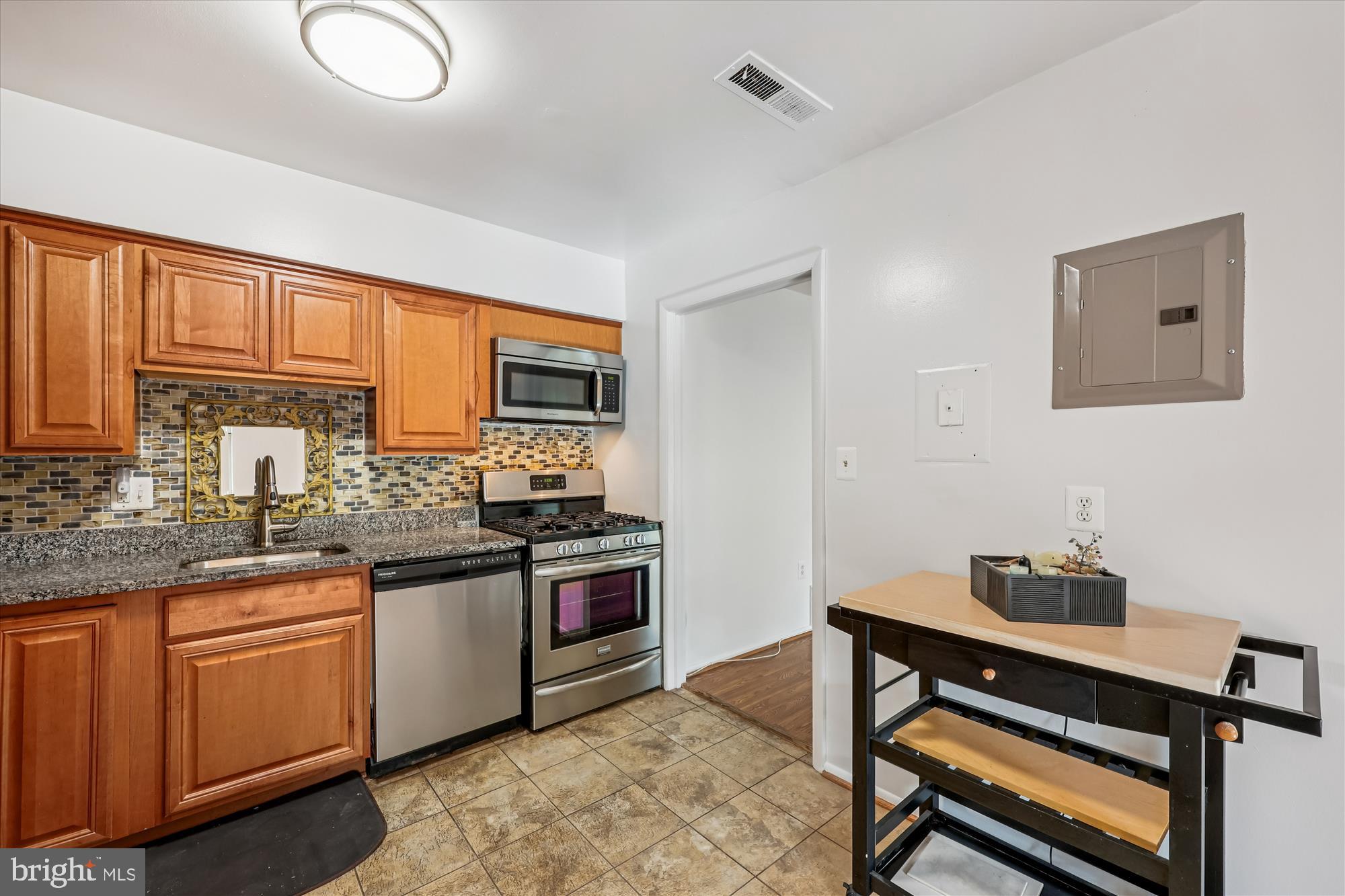 14428 Parkvale Road, Unit 3 Rockville, MD 20853 - Photo 12 of 37 a kitchen with stainless steel appliances granite countertop a stove and cabinets