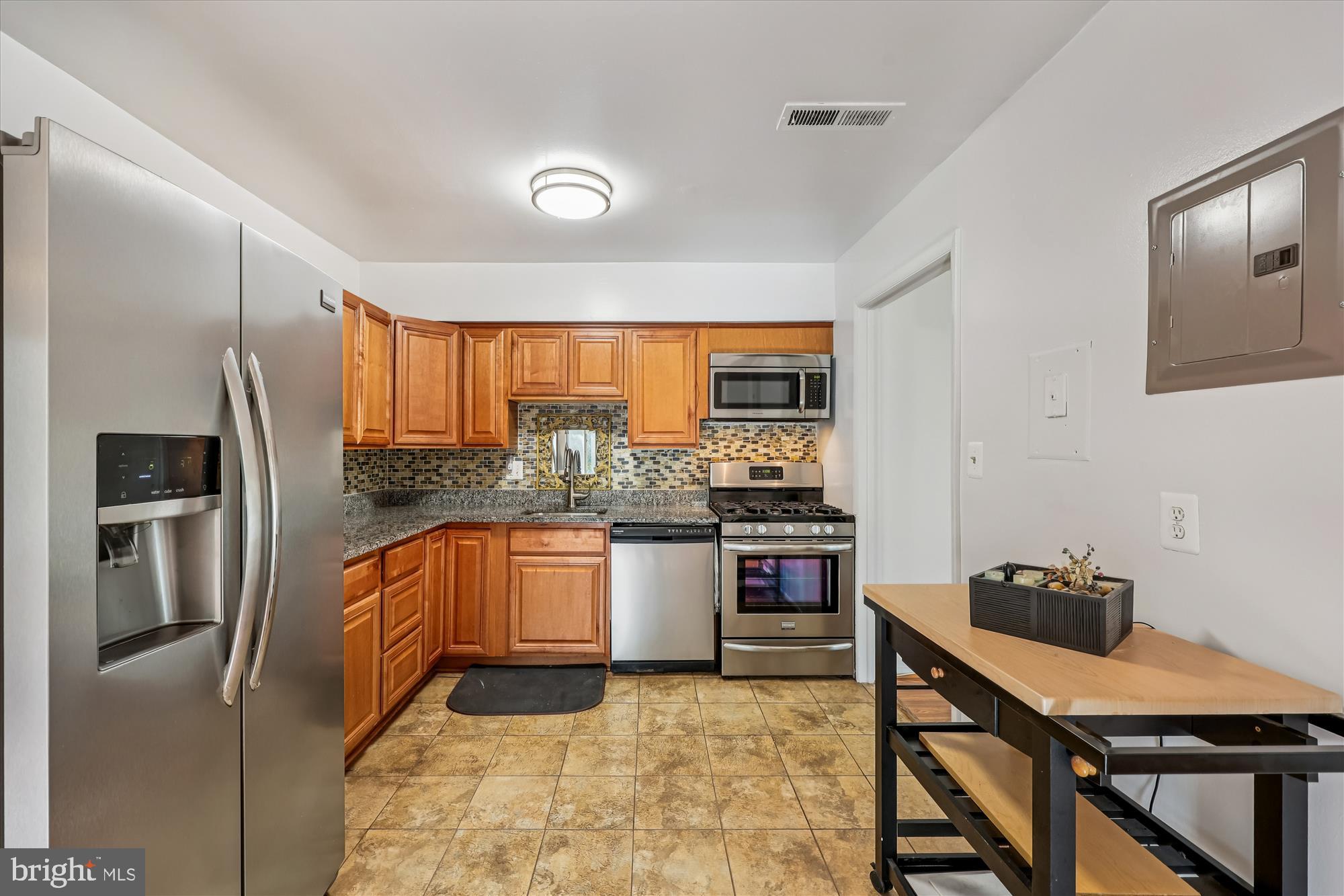 14428 Parkvale Road, Unit 3 Rockville, MD 20853 - Photo 13 of 37 a kitchen with stainless steel appliances granite countertop a refrigerator and a stove top oven