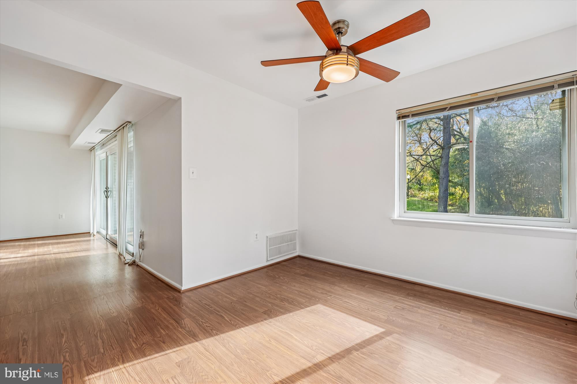 14428 Parkvale Road, Unit 3 Rockville, MD 20853 - Photo 19 of 37 an empty room with wooden floor fan and windows