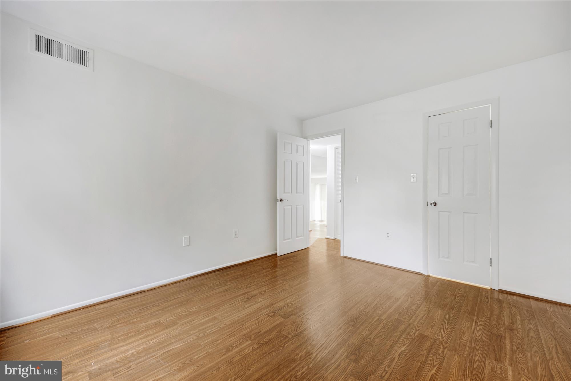 14428 Parkvale Road, Unit 3 Rockville, MD 20853 - Photo 23 of 37 a view of an empty room with wooden floor