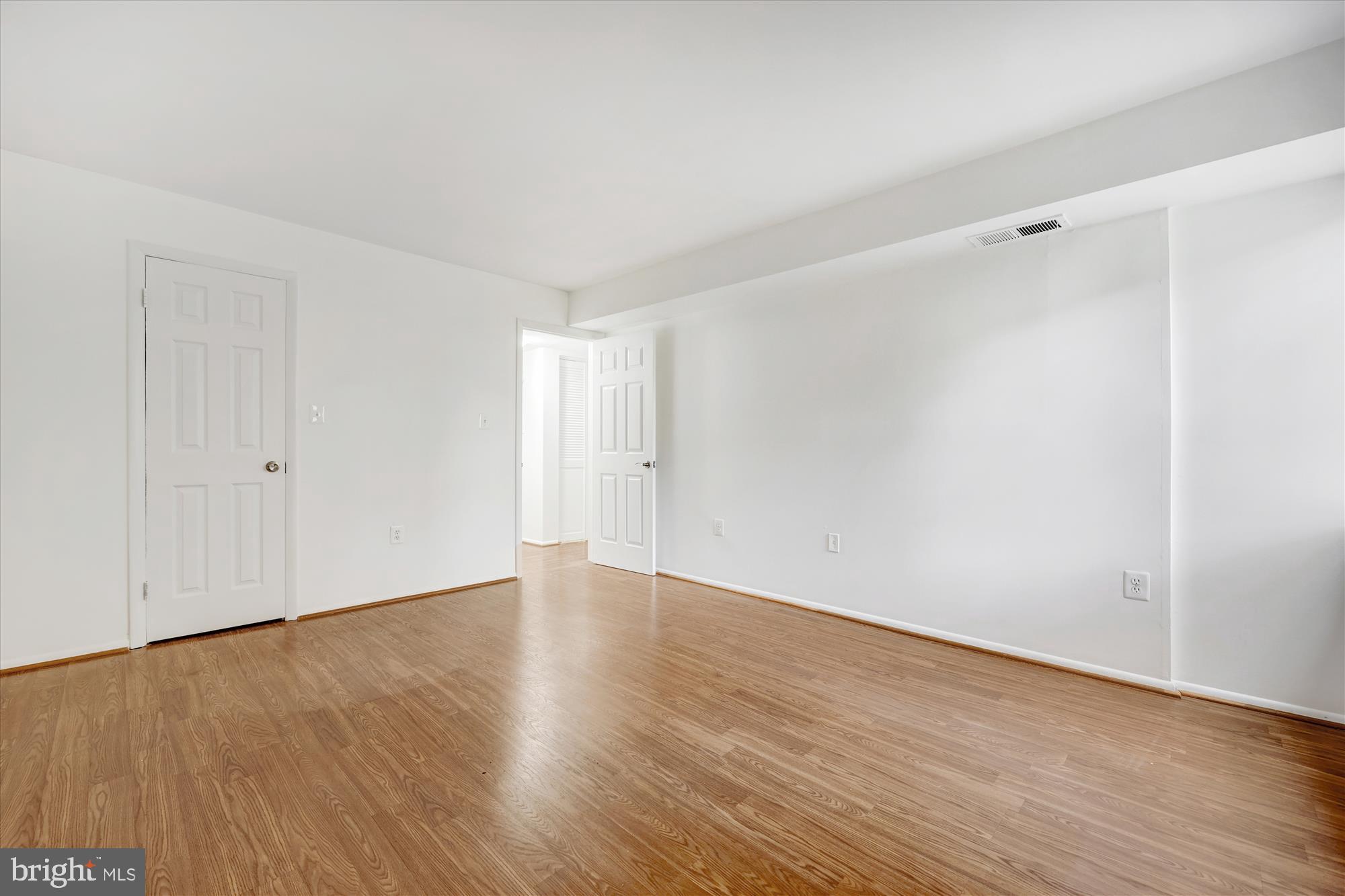14428 Parkvale Road, Unit 3 Rockville, MD 20853 - Photo 27 of 37 a view of an empty room with wooden floor