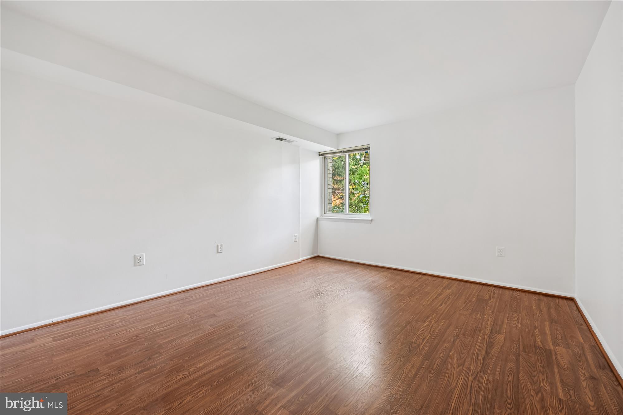 14428 Parkvale Road, Unit 3 Rockville, MD 20853 - Photo 30 of 37 an empty room with a window and wooden floor