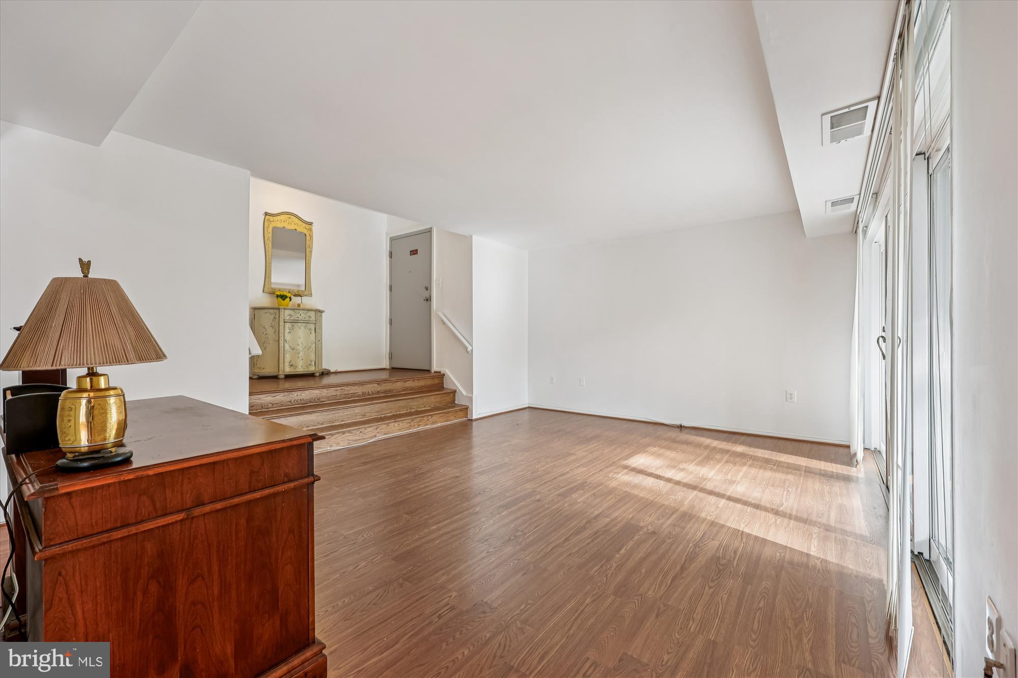 14428 Parkvale Road, Unit 3 Rockville, MD 20853 - Photo 8 of 37 a view of kitchen and empty room with wooden floor