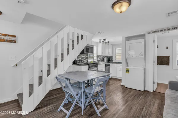 a view of a dining room with furniture and wooden floor