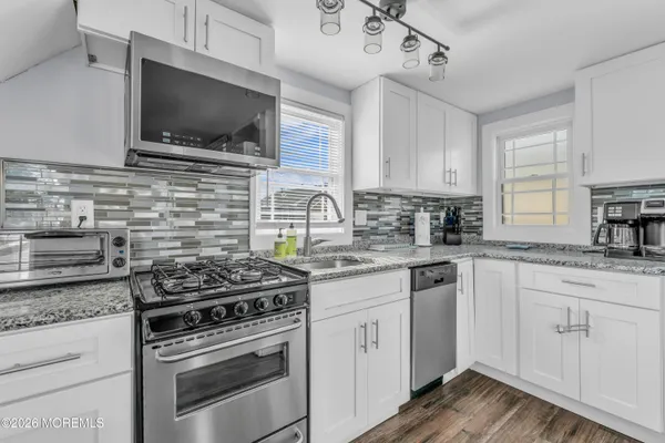 a kitchen with cabinets appliances and a window