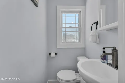 a white toilet sitting next to a bathroom sink