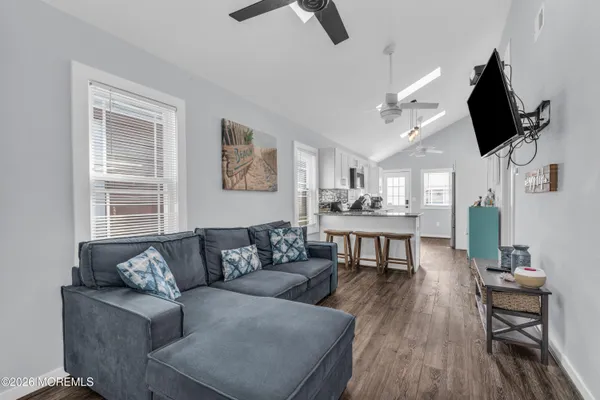 a living room with furniture and a wooden floor