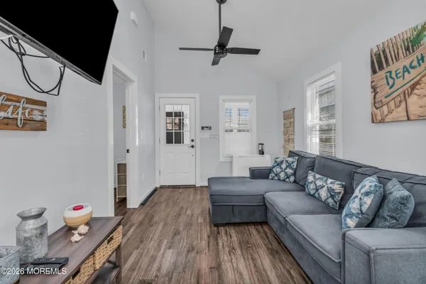 a living room with furniture and wooden floor
