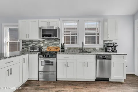 a kitchen with stainless steel appliances granite countertop a stove and a sink