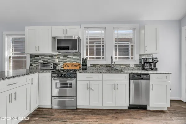 a kitchen with stainless steel appliances granite countertop a stove and a sink