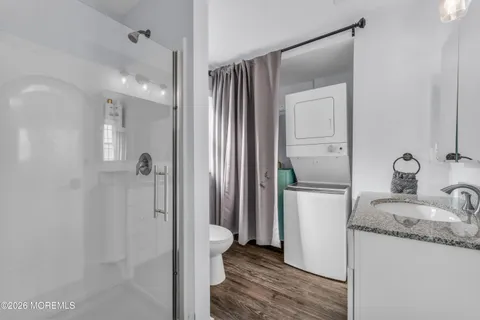 a bathroom with a granite countertop sink mirror and shower