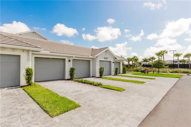 a front view of house with outdoor space and trees