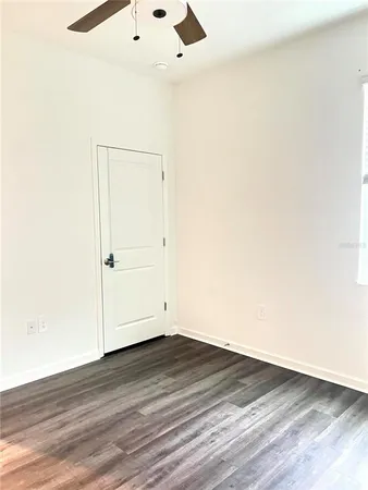 an empty room with wooden floor