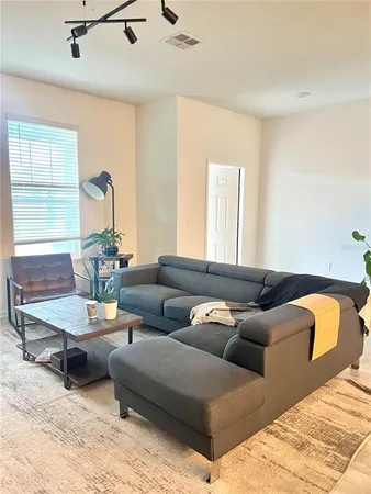 a living room with furniture and a large window