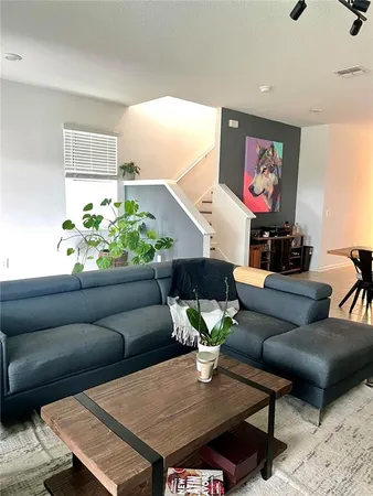 a living room with furniture and a potted plant