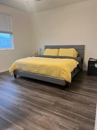 a bed sitting in a bedroom next to a window