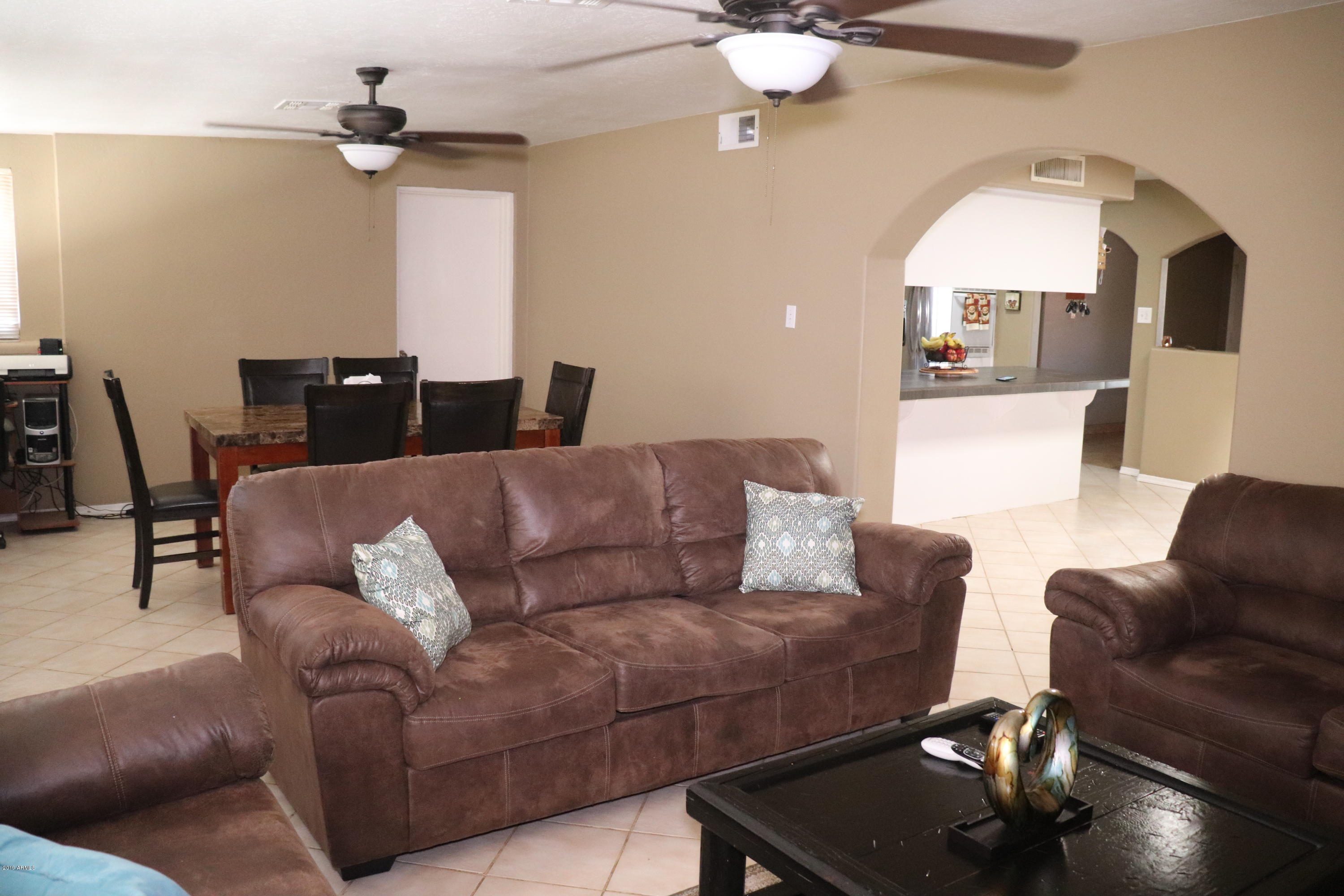 8233 West Osborn Road Phoenix, AZ 85033 - Photo 11 of 28 a living room with furniture and a window