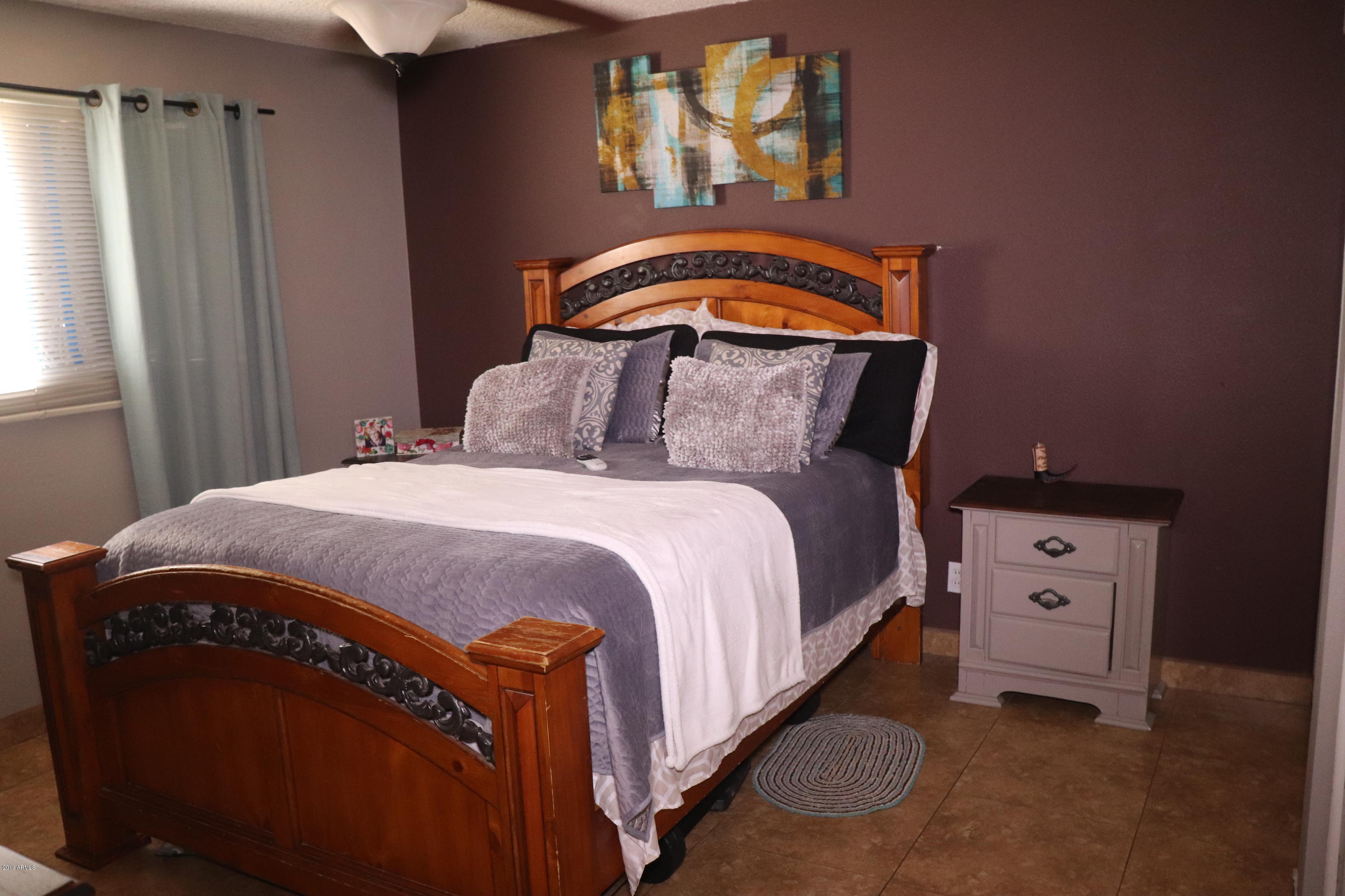 8233 West Osborn Road Phoenix, AZ 85033 - Photo 12 of 28 a bedroom with a bed and a window