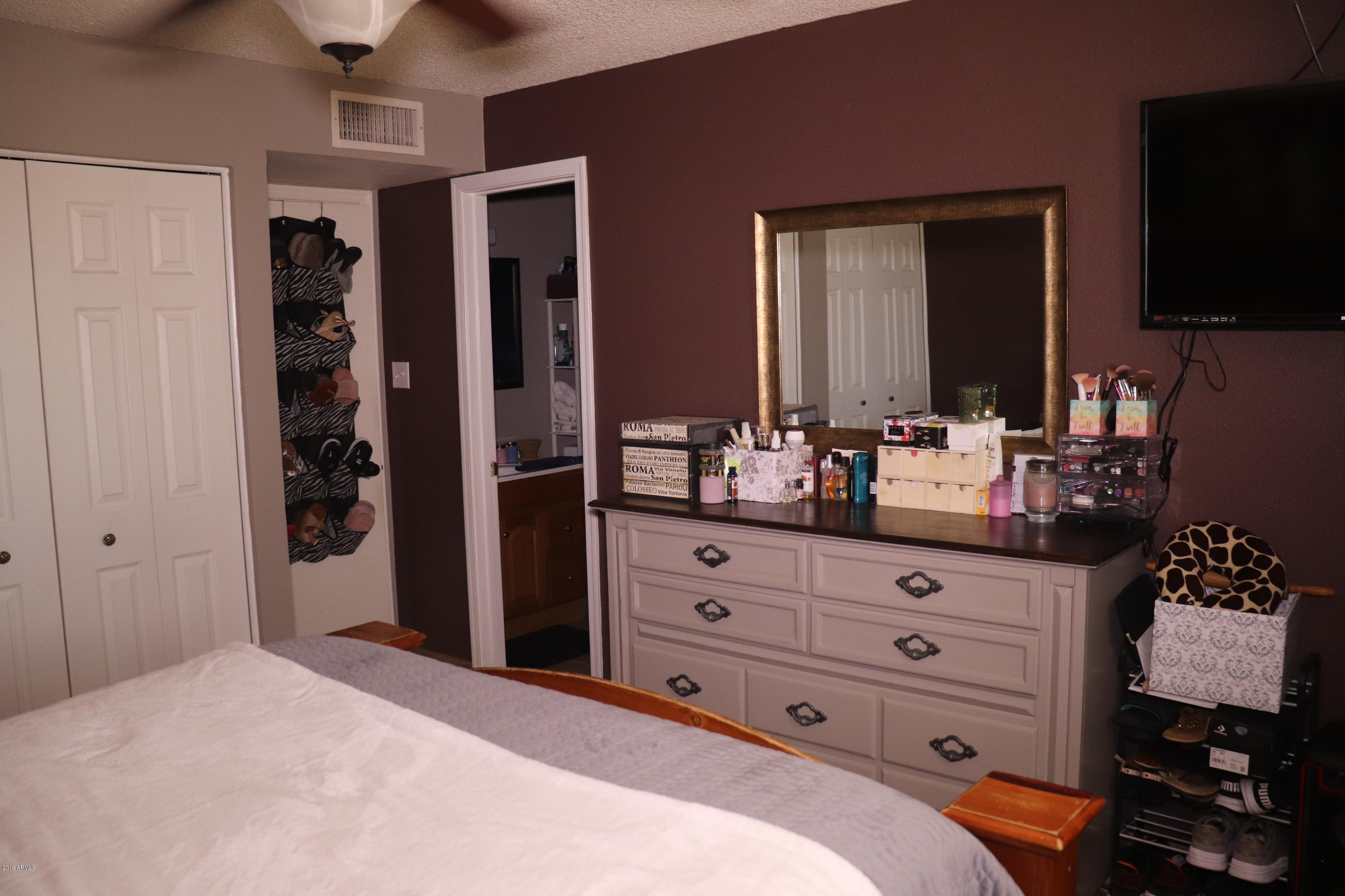 8233 West Osborn Road Phoenix, AZ 85033 - Photo 13 of 28 a bedroom with a bed and a flat screen tv