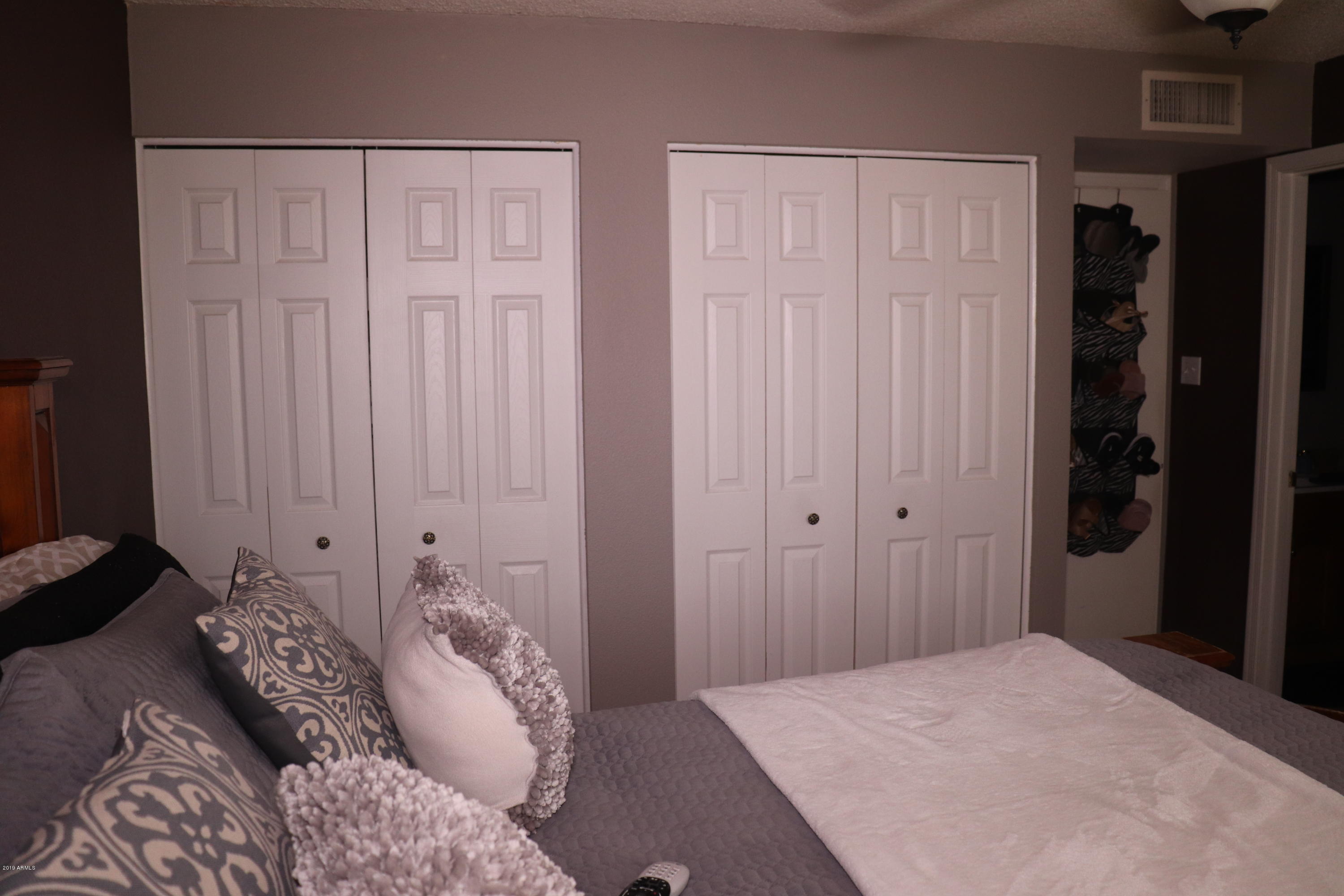 8233 West Osborn Road Phoenix, AZ 85033 - Photo 14 of 28 a bedroom with a bed and a closet