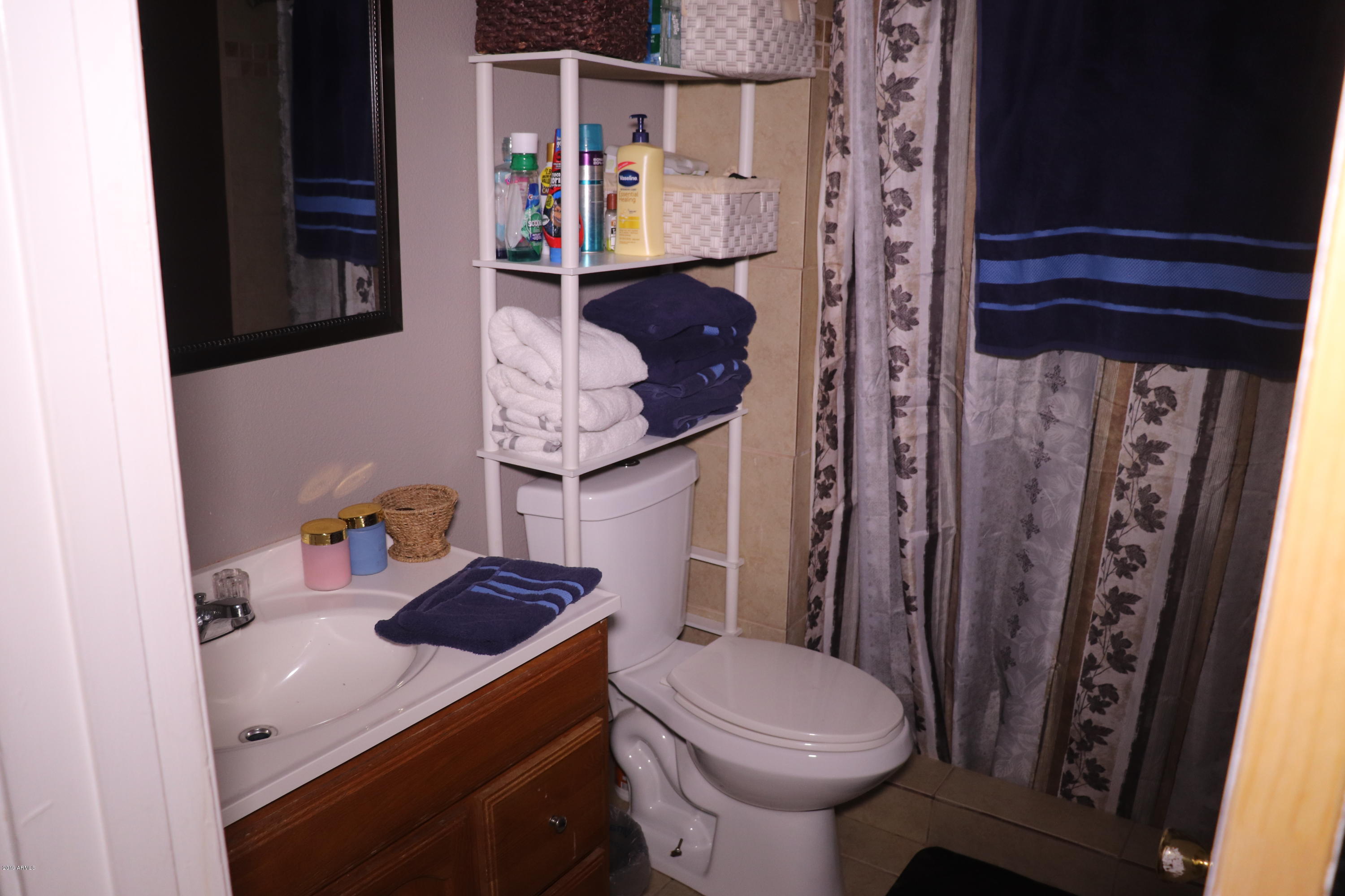 8233 West Osborn Road Phoenix, AZ 85033 - Photo 15 of 28 a bathroom with a sink a toilet and shower