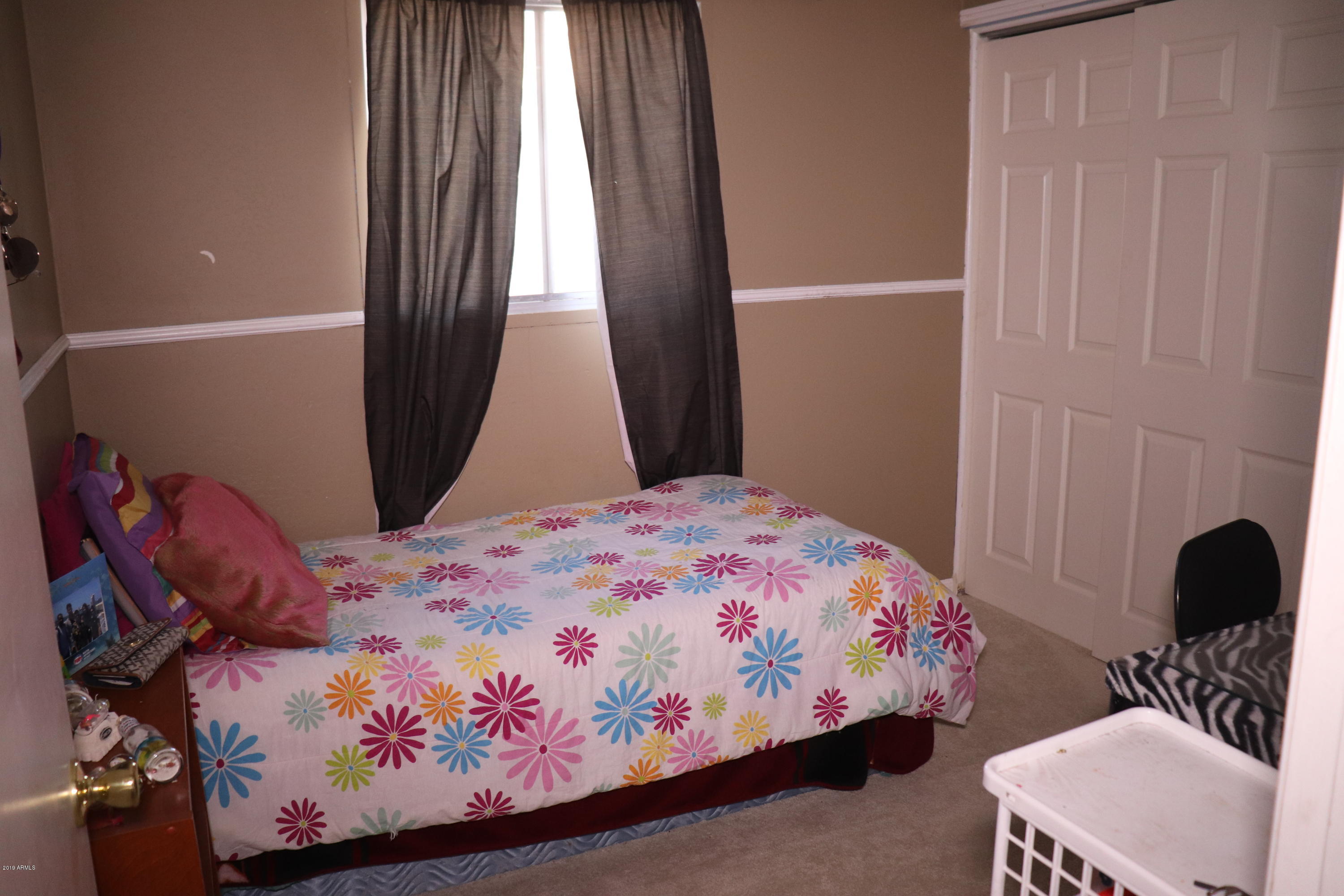 8233 West Osborn Road Phoenix, AZ 85033 - Photo 16 of 28 a bedroom with a bed and a window
