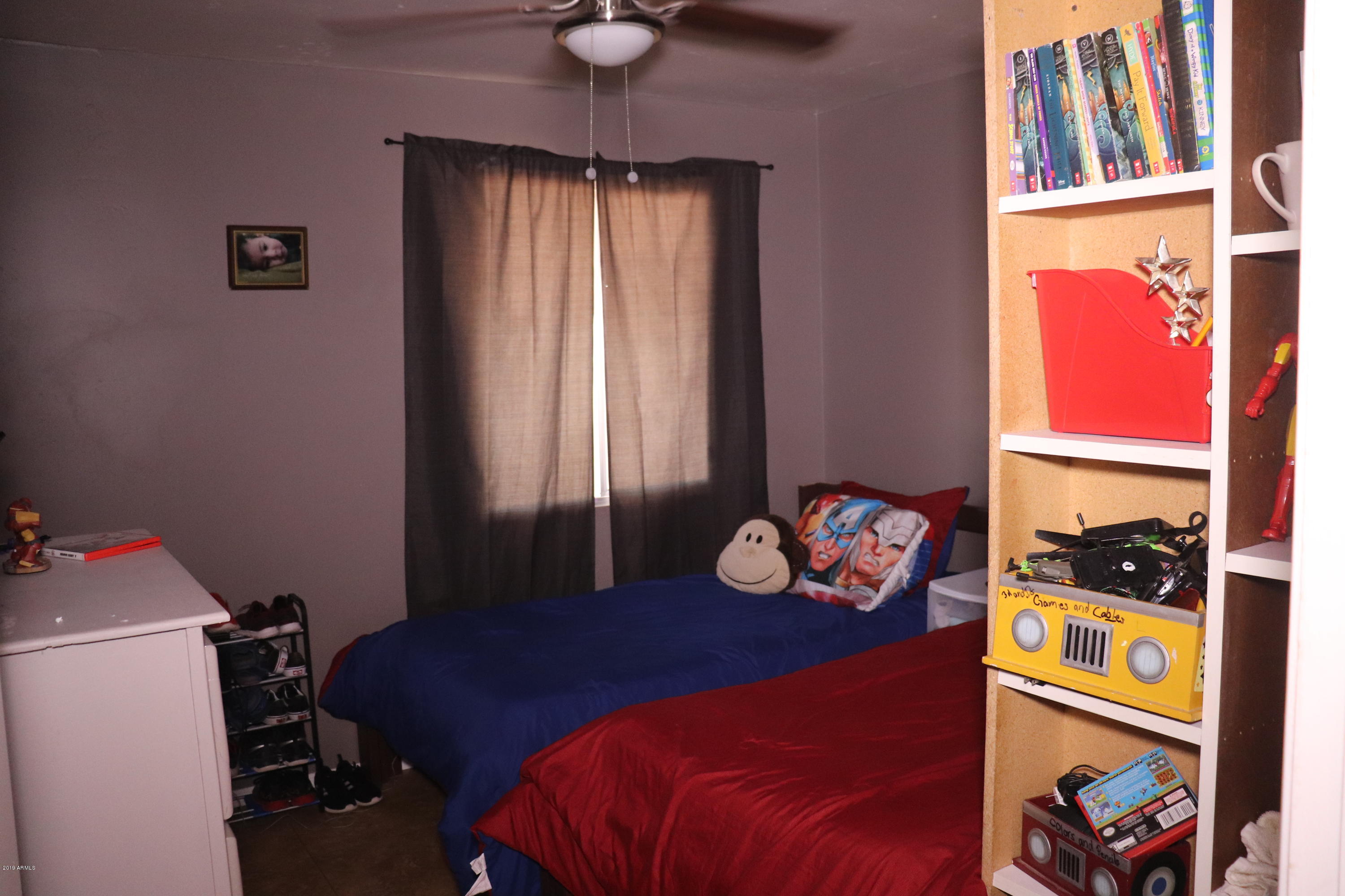 8233 West Osborn Road Phoenix, AZ 85033 - Photo 19 of 28 a bedroom with a bed and a window