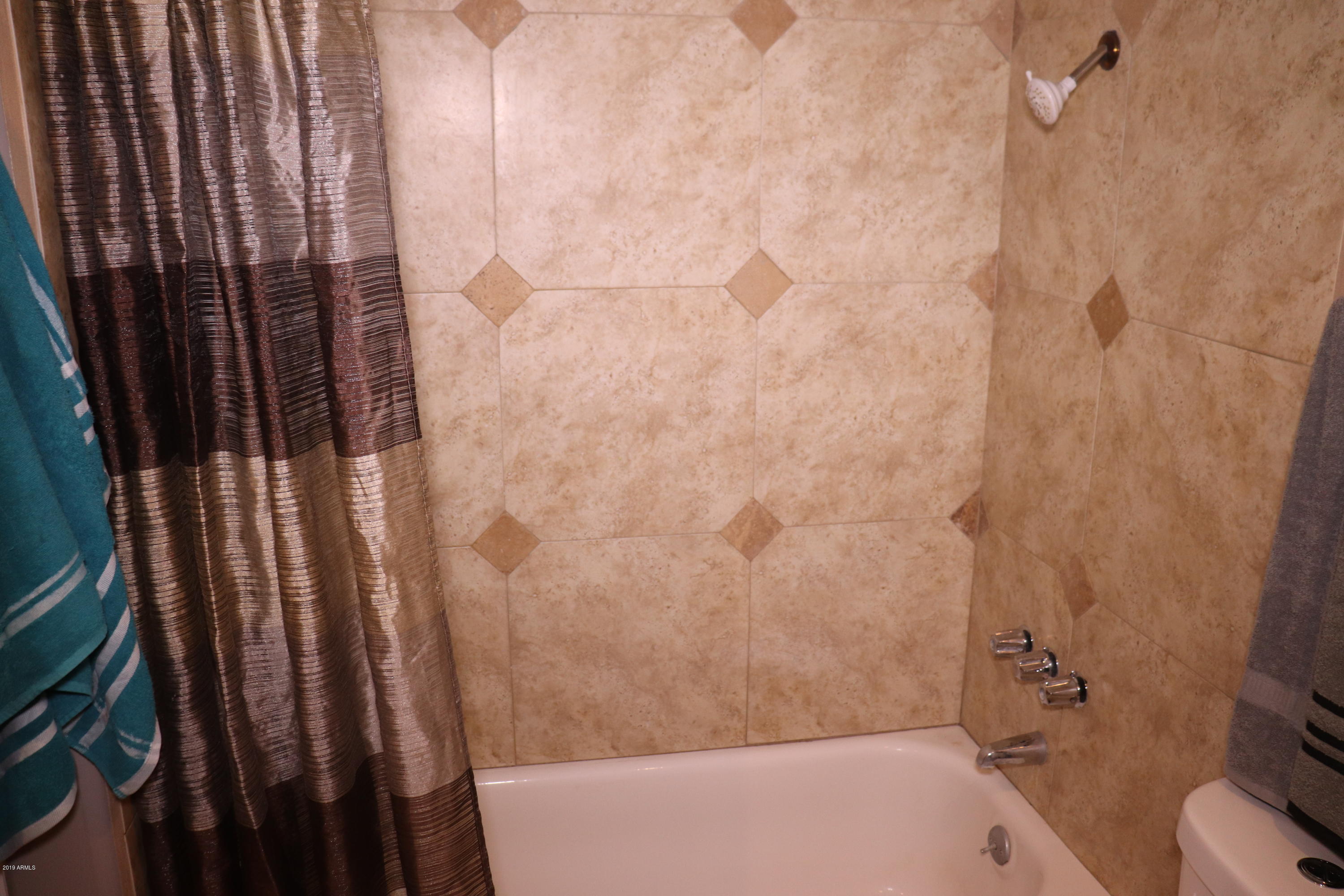 8233 West Osborn Road Phoenix, AZ 85033 - Photo 22 of 28 a bathroom with a bathtub
