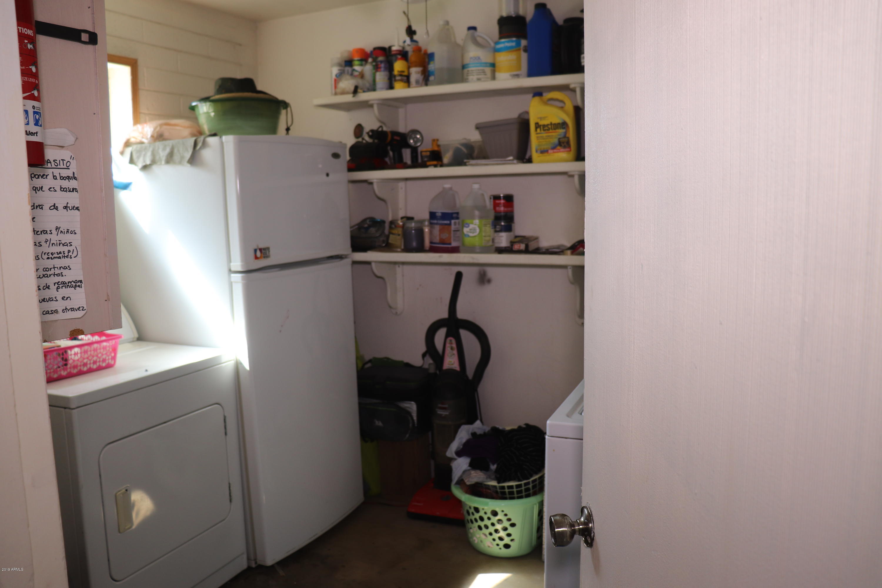 8233 West Osborn Road Phoenix, AZ 85033 - Photo 23 of 28 a kitchen with a refrigerator and cabinets