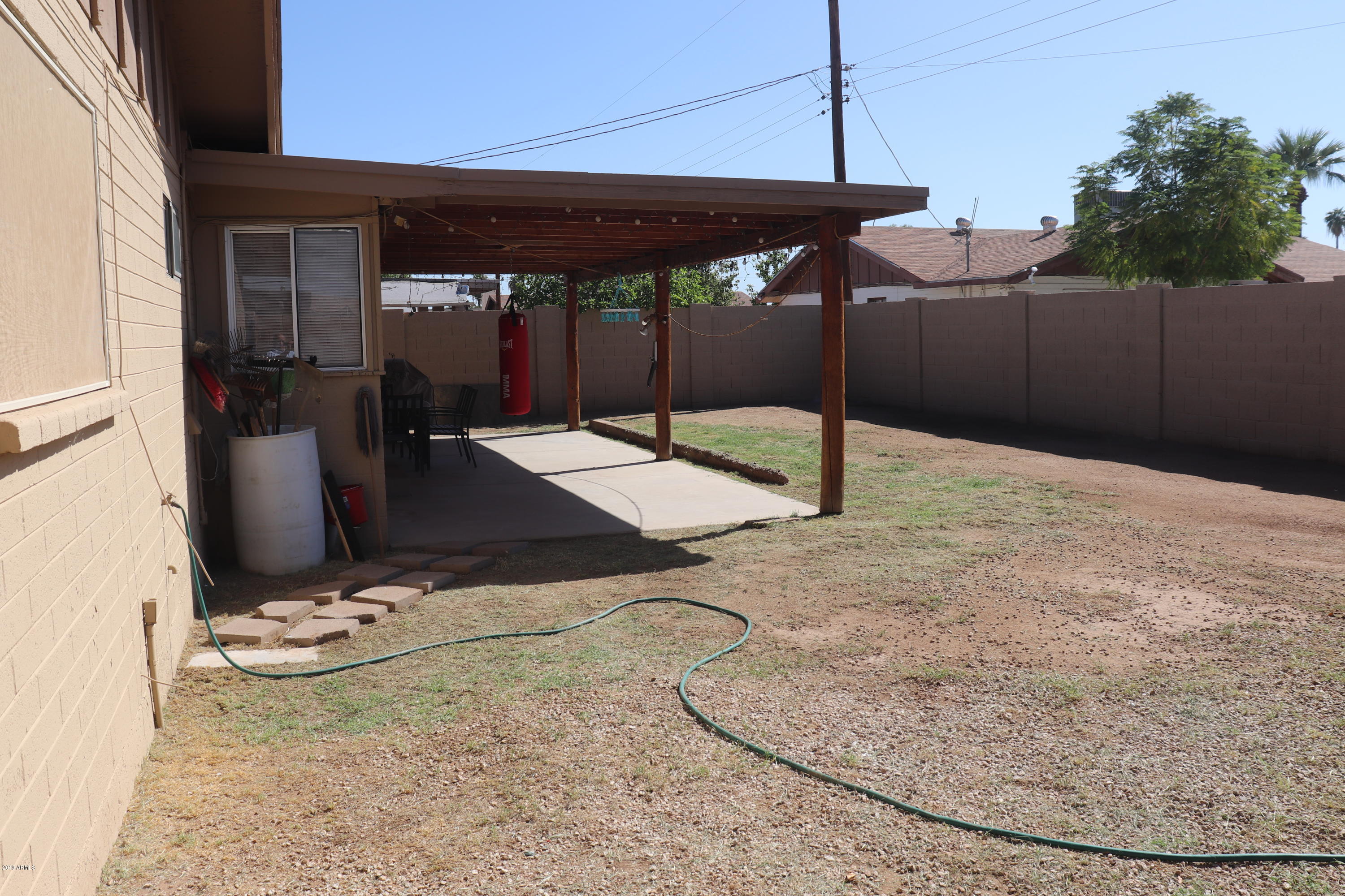 8233 West Osborn Road Phoenix, AZ 85033 - Photo 27 of 28 a room with wooden floor and glass door