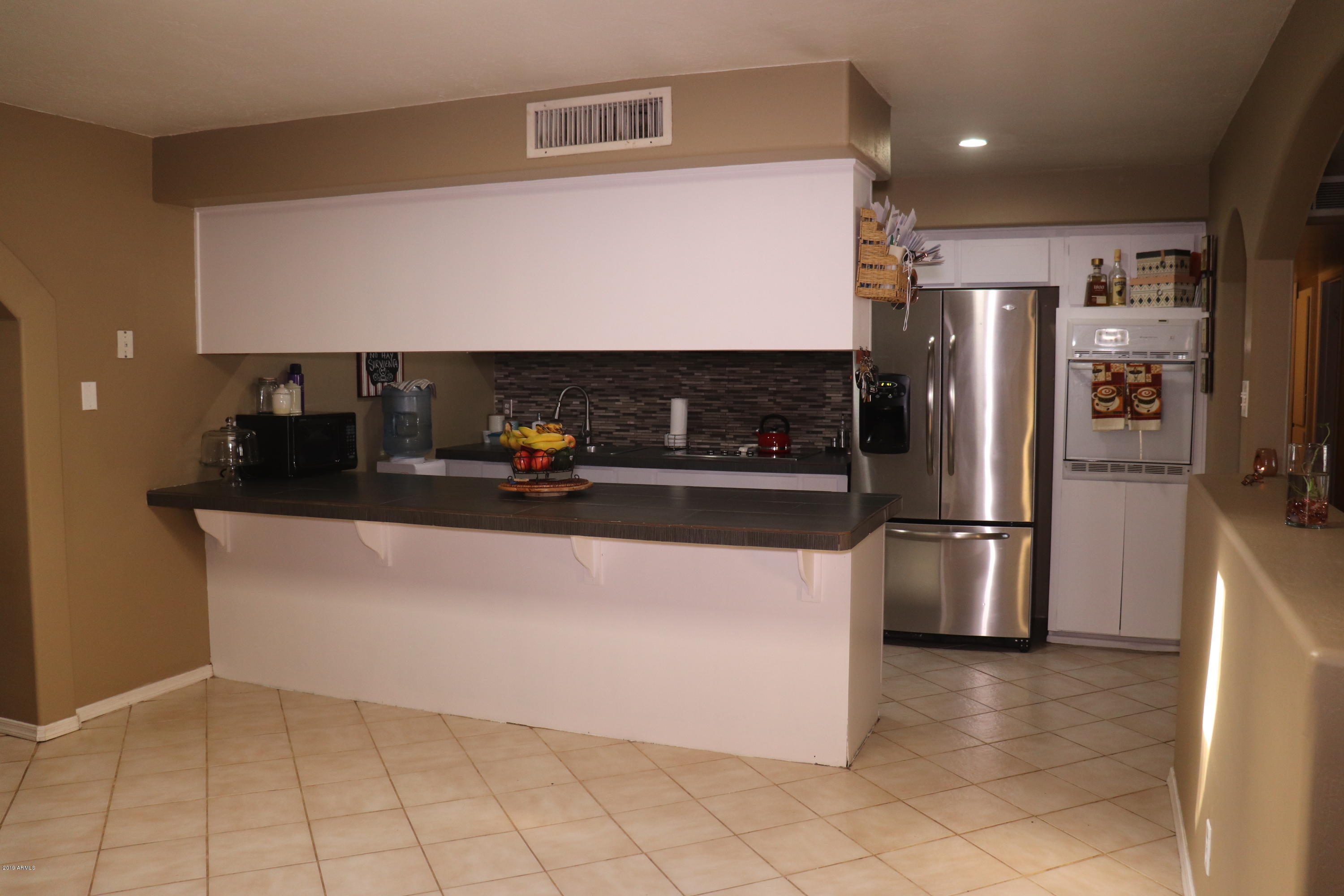 8233 West Osborn Road Phoenix, AZ 85033 - Photo 5 of 28 a kitchen with stainless steel appliances a refrigerator and a stove