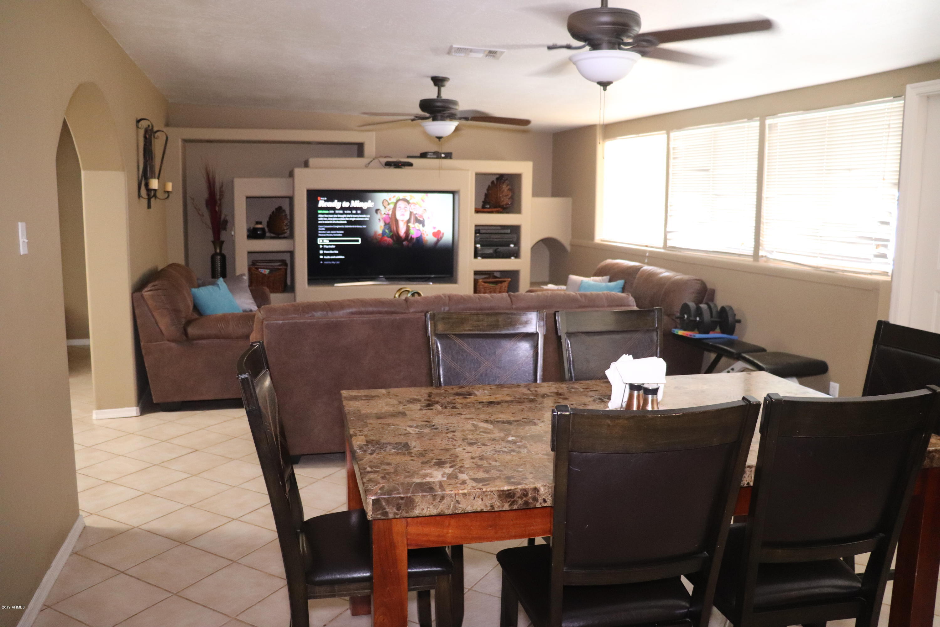 8233 West Osborn Road Phoenix, AZ 85033 - Photo 10 of 28 a living room with fireplace furniture and a flat screen tv