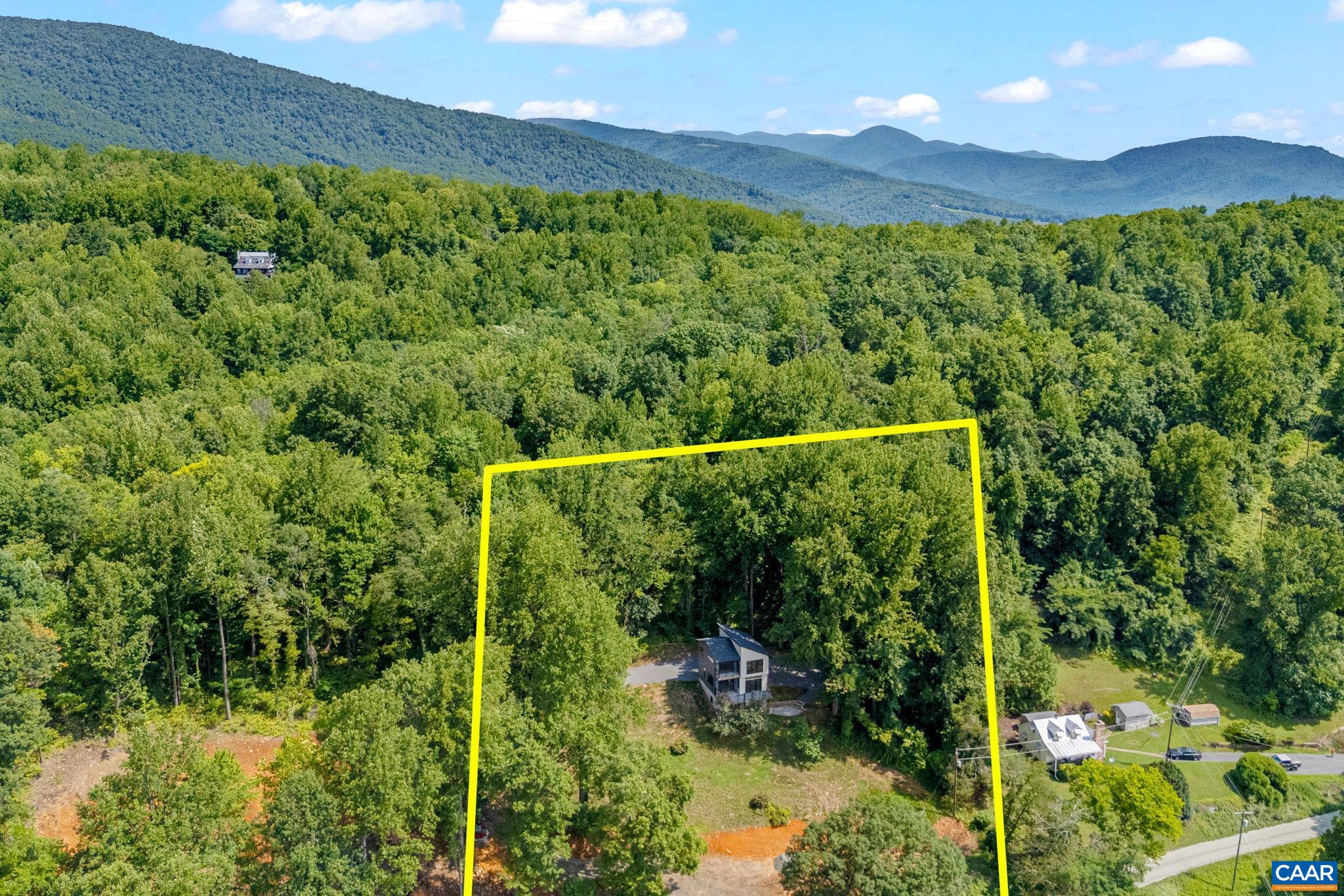 181 Turkey Ridge Road Stanardsville, VA 22973 - Photo 8 of 38 a view of a lush green forest with a lake