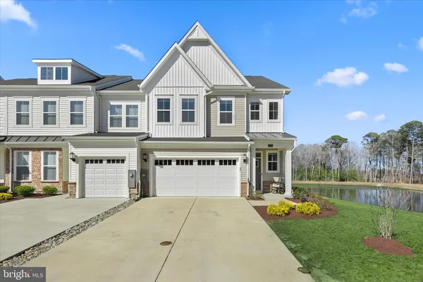 a front view of a building with a garden and slide