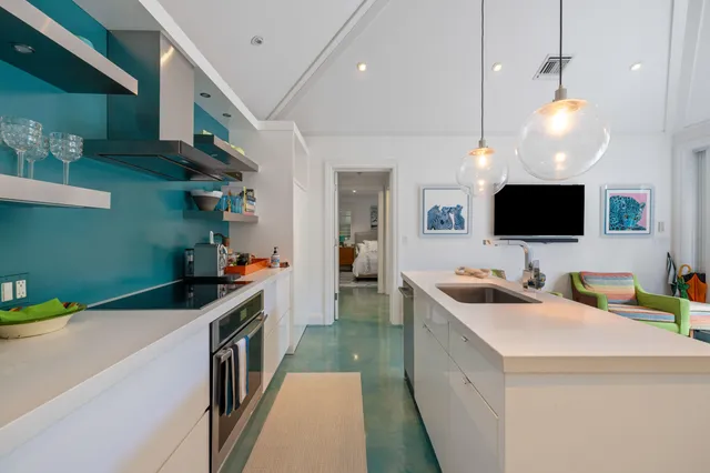 a kitchen that has a lot of cabinets and wooden floor