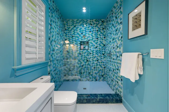 a bathroom with a toilet a sink and a mirror