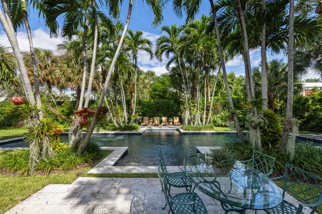 a view of backyard with swimming pool and outdoor seating