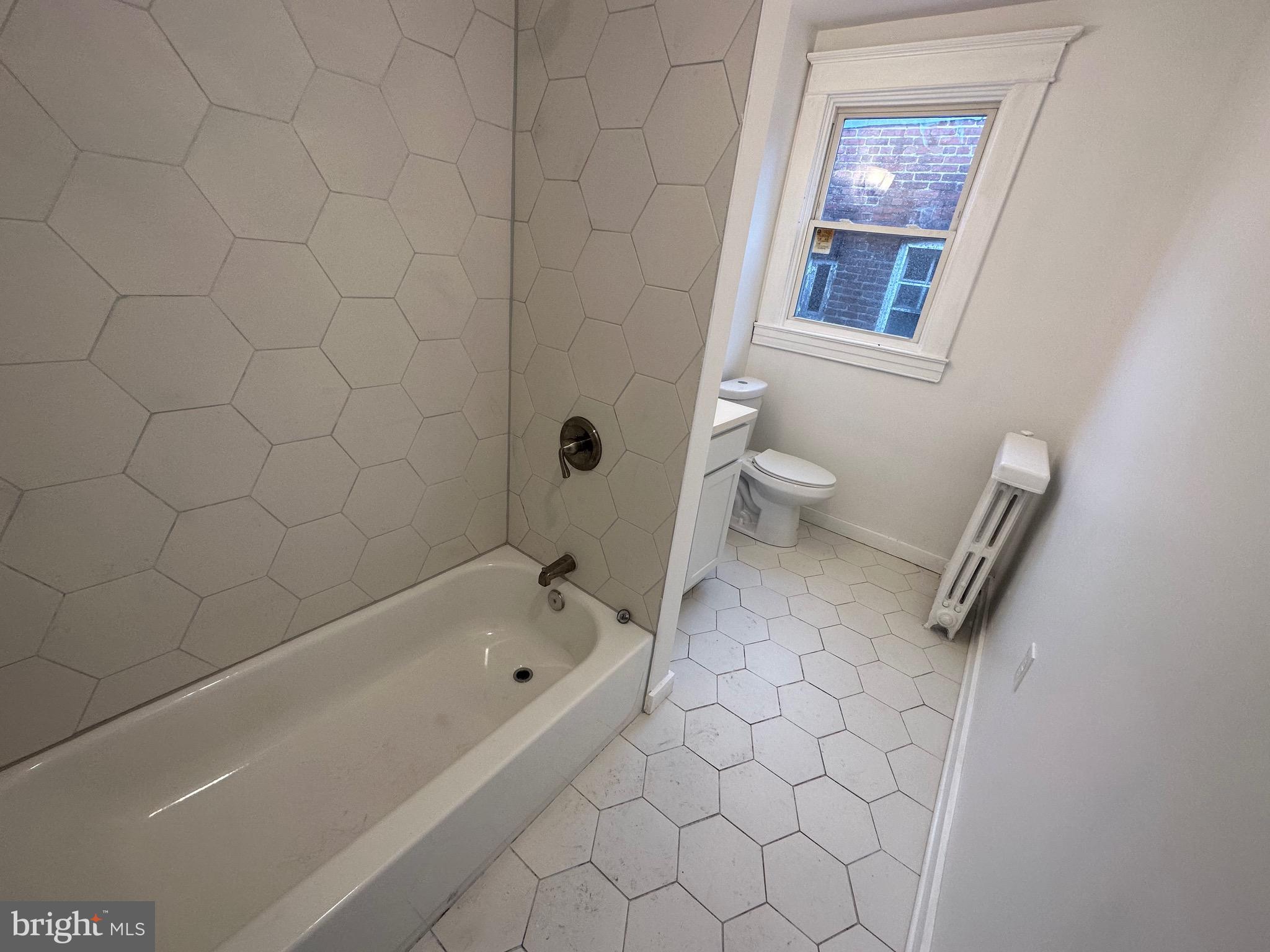 4227 Euclid Avenue, Unit B Baltimore, MD 21229 - Photo 1 of 87 a bathroom with a bathtub and a toilet