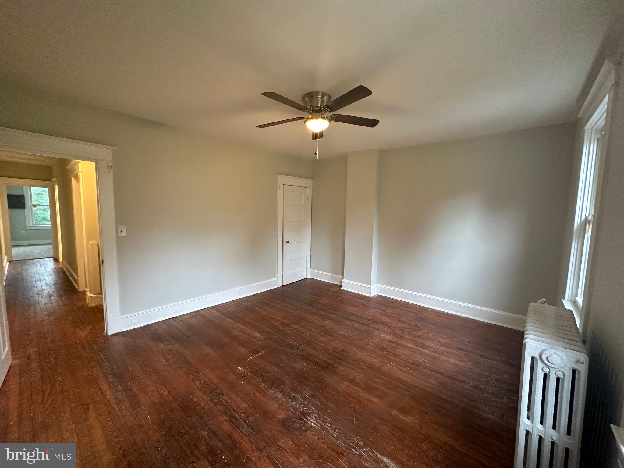4227 Euclid Avenue, Unit B Baltimore, MD 21229 - Photo 11 of 87 a view of empty room with wooden floor and fan