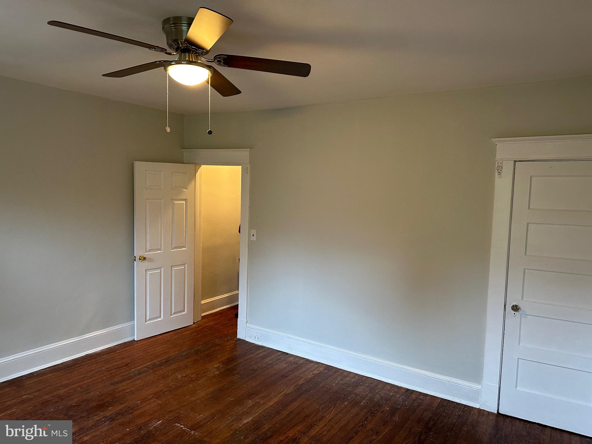 4227 Euclid Avenue, Unit B Baltimore, MD 21229 - Photo 14 of 87 an empty room with wooden floor closet and chandelier fan